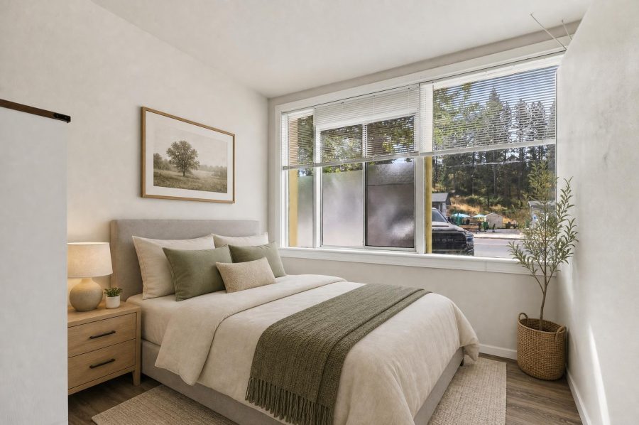 Unit 2 bedroom, virtually staged with a queen bed beneath the large picture window