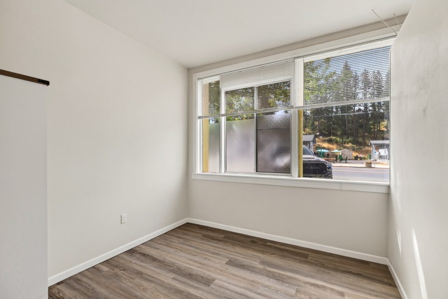 Unit 2 bedroom, unfurnished, with a large picture window overlooking the street and hillside