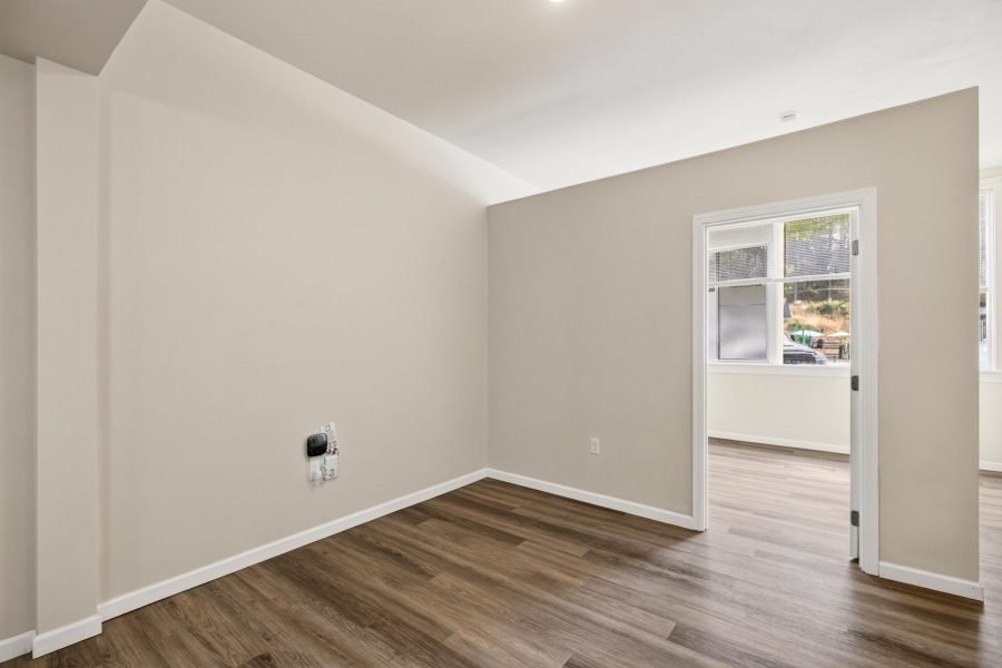 Unit 2 flex room from the other end, with a doorway through to the bedroom