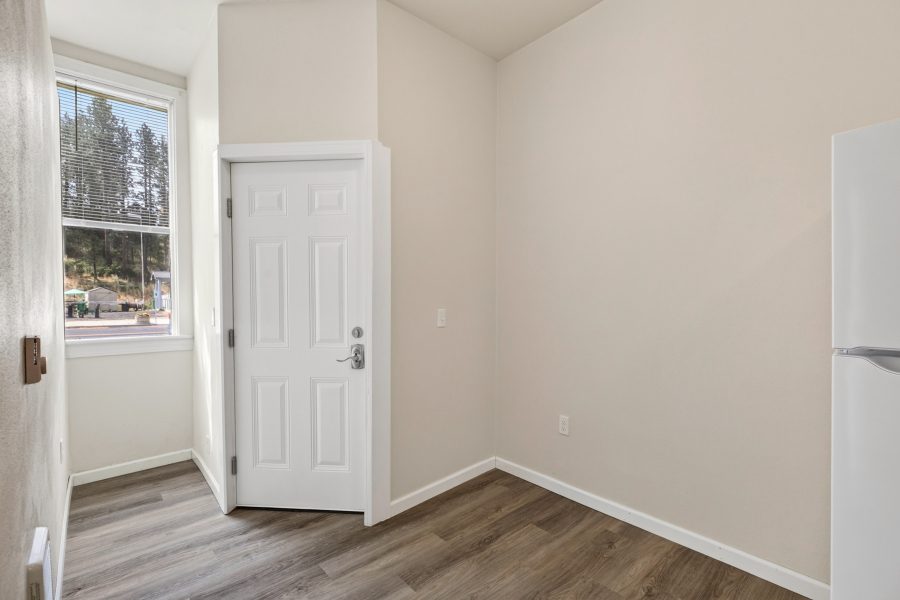 Unit 2 kitchen corner with a private exterior door and a window looking out to the hillside