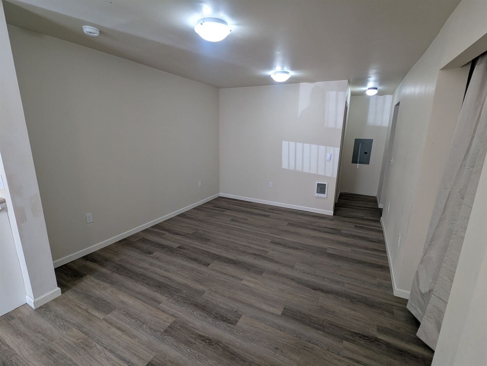 Open living area with new gray LVP flooring in Unit 2