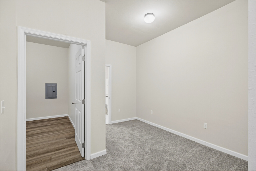Unit 3 carpeted bedroom with a doorway to an adjacent room