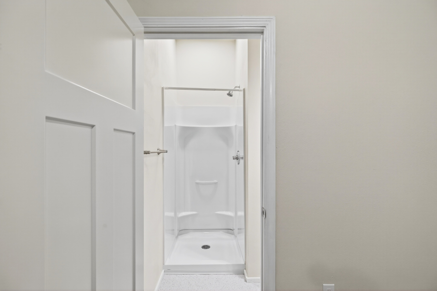 Unit 3 walk-in shower viewed through the bathroom doorway