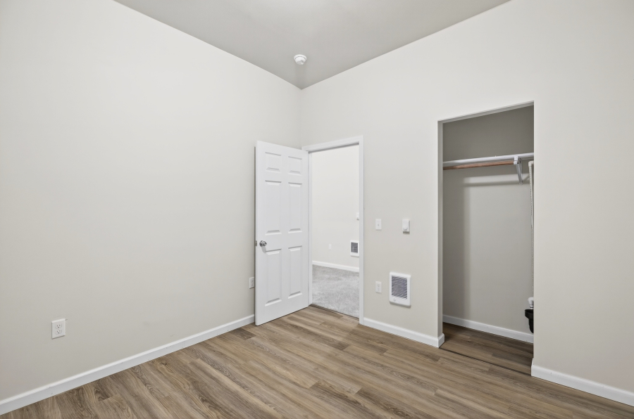 Unit 3 bedroom with vinyl plank flooring and a closet